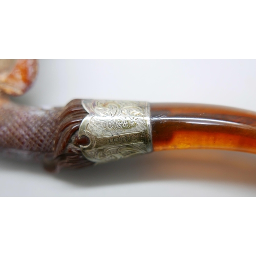 939 - An early 20th Century eagle's claw, pipe, with amber stem and silver collar, cased Meerschaum