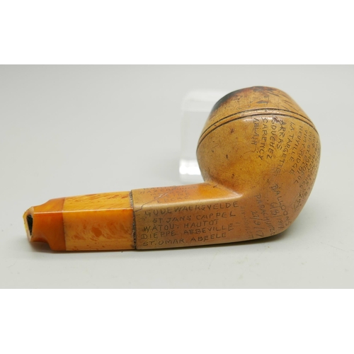 942 - An early 20th Century Meerschaum pipe, missing end of amber stem, carved with fifty-two different lo... 