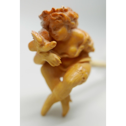 943 - A carved Meerschaum pipe of a scantily clad young lady, with bone stem separate, cased