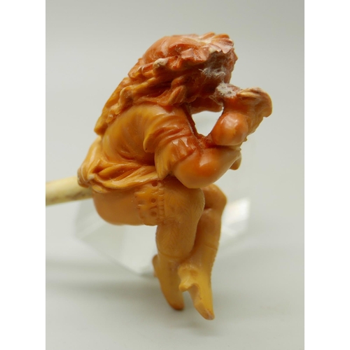 943 - A carved Meerschaum pipe of a scantily clad young lady, with bone stem separate, cased