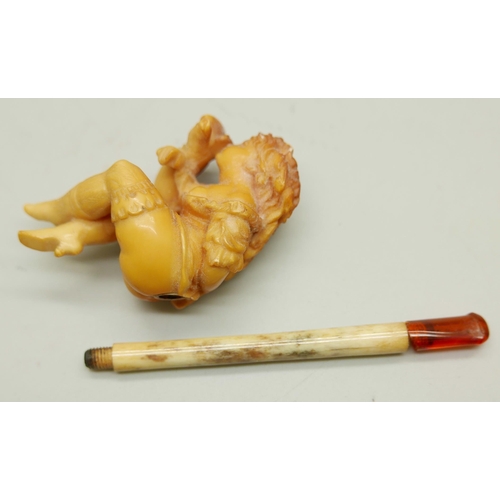 943 - A carved Meerschaum pipe of a scantily clad young lady, with bone stem separate, cased