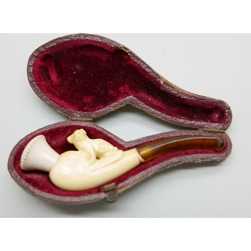 944 - Three carved Meerschaum pipes, cased