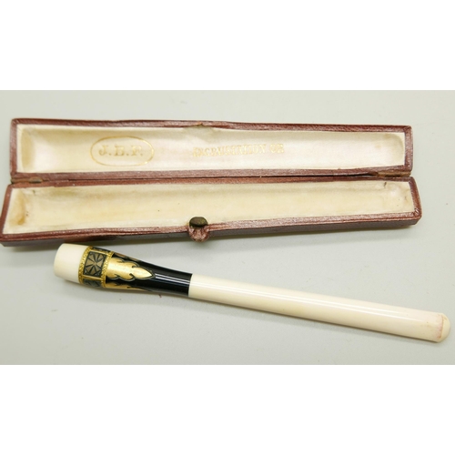 953 - A smoker's pipe with a 9ct gold collar and a cigarette holder, both cased