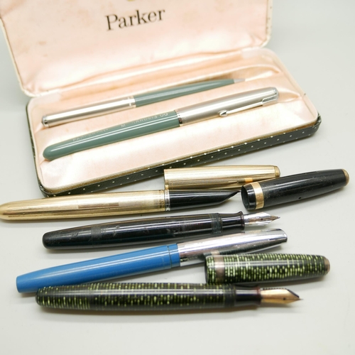 975 - A cased Parker pen set, three other Parker pens and a Sheaffer