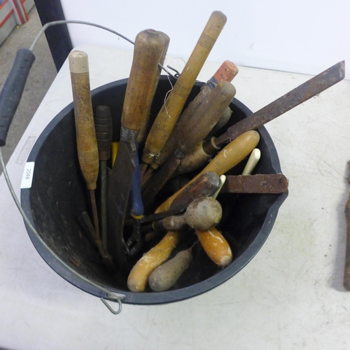 2048 - A bucket of woodworking tools including chisels, axe, saws, clamp, etc.