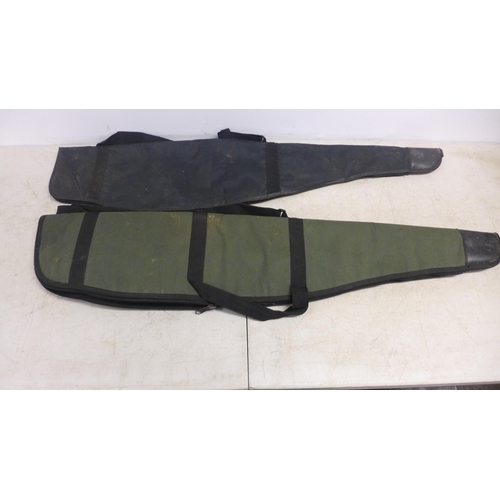 2086 - Three canvas gun cases and a brown leather gun case