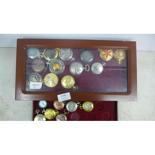 2108 - A display cabinet with three drawers of pocket watches