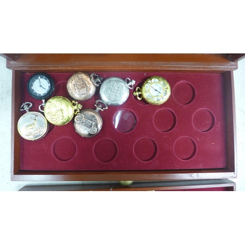 2108 - A display cabinet with three drawers of pocket watches