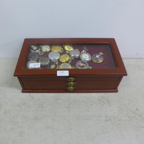 2110 - A display cabinet with three drawers of pocket watches