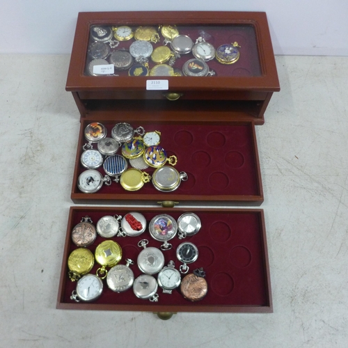 2110 - A display cabinet with three drawers of pocket watches