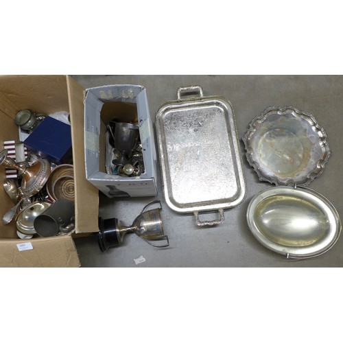 1257 - Two boxes of plated ware including a pair of candlesticks, two plated trays, napkin rings, silver pl... 