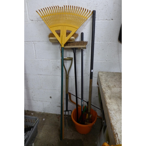 2225 - Approx. 6 garden tools including bow saw, rakes, brushes, a bucket, pitch fork, etc.