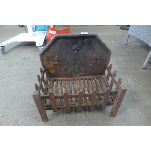 2289 - 2 Cast metal dog grates and a brass coal scuttle