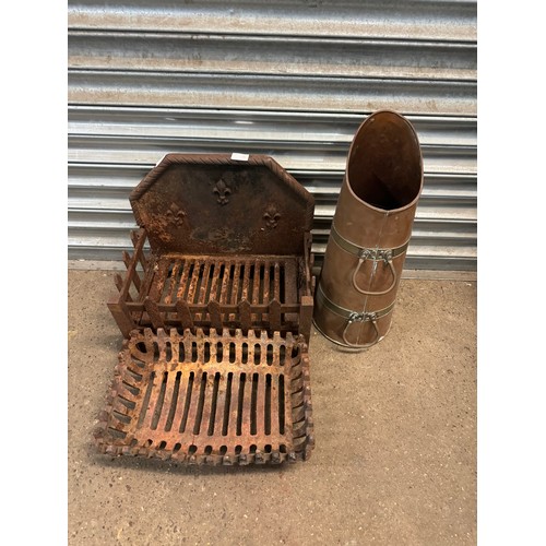 2289 - 2 Cast metal dog grates and a brass coal scuttle