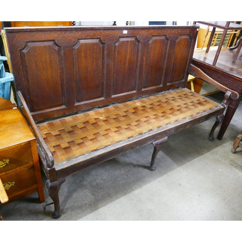 305 - A George III panelled oak settle