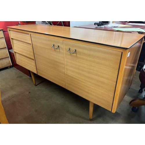 135 - A teak dining suite, comprising; sideboard, table and chairs, including child's chair