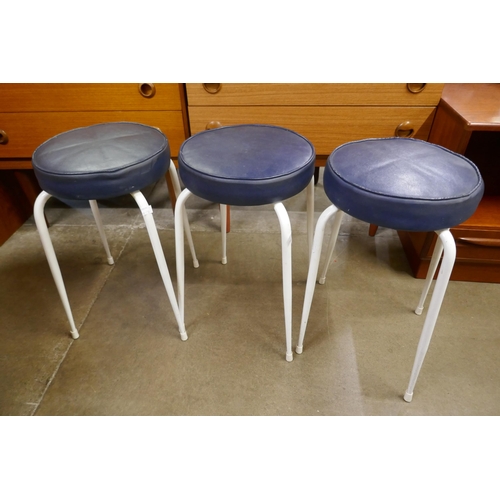 119 - A set of three white tubular metal stacking stools