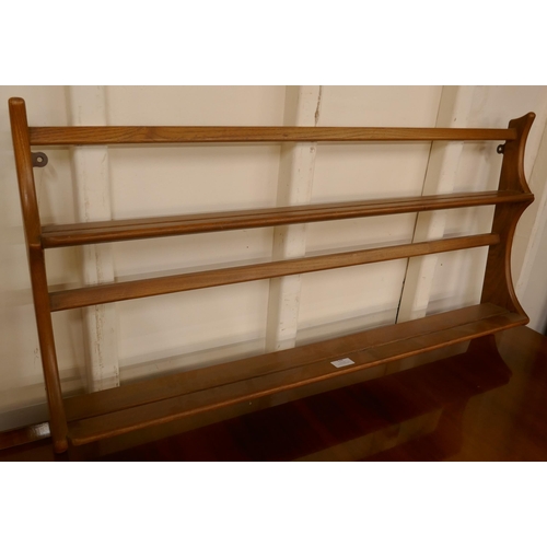 128 - An Ercol Blonde elm wall hanging plate rack