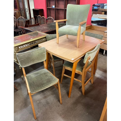 135 - A teak dining suite, comprising; sideboard, table and chairs, including child's chair