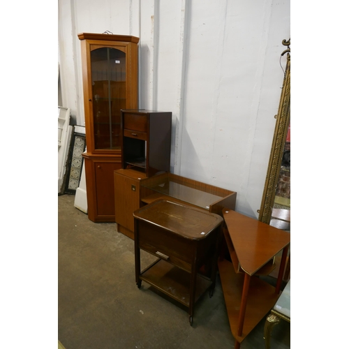 138 - A teak corner cabinet, a telephone table, a corner table, bedside table and a trolley