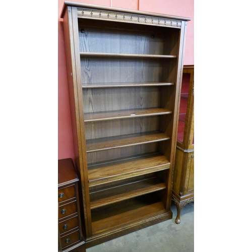 145 - A tall Ercol Golden Dawn ash open bookcase