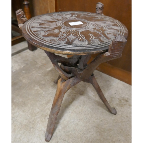 157 - A small African carved hardwood table