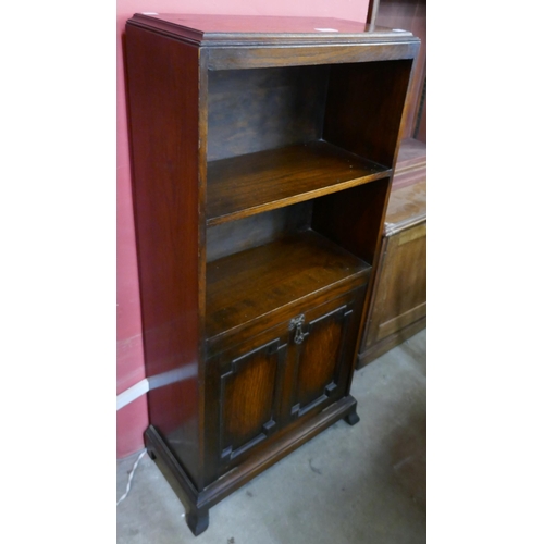 175 - An oak bookcase with integral magazine rack