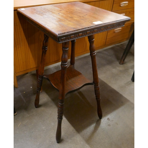 186 - A late Victorian carved oak occasional table