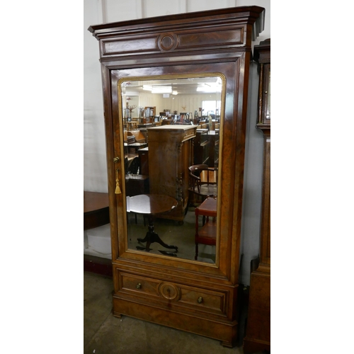 195 - A 19th Century French Empire style mahogany single door armoire