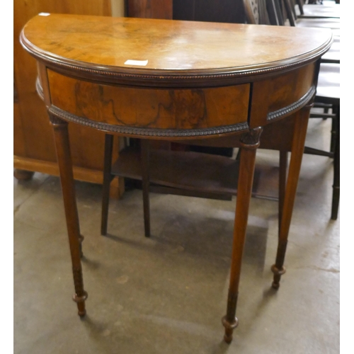 196 - A Queen Anne style walnut demi-lune fold-over card table