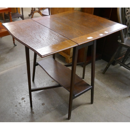 198 - A Liberty's style Arts and Crafts oak drop-leaf table