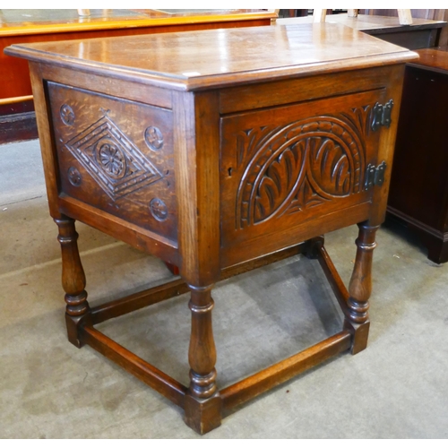 221 - A carved oak credence cupboard