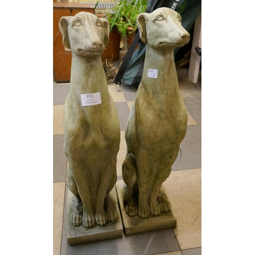 355 - A pair of concrete garden figures of seated greyhounds