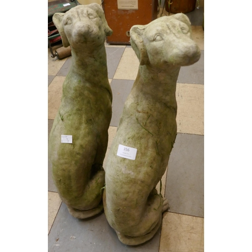 356 - A pair of concrete garden figures of seated greyhounds