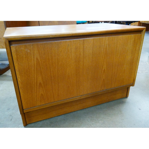 73 - A small teak fall front cabinet