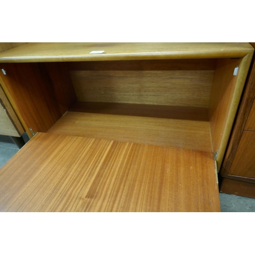 73 - A small teak fall front cabinet