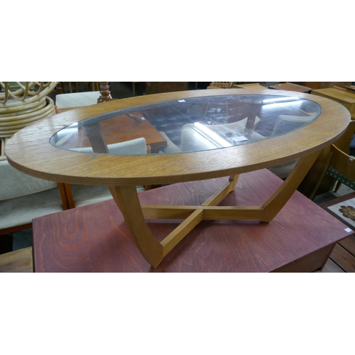 91 - A teak and glass topped oval coffee table