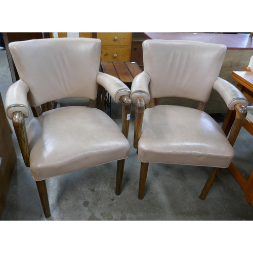 94 - A pair of Laszlo Hoenig hardwood and leather elbow chairs