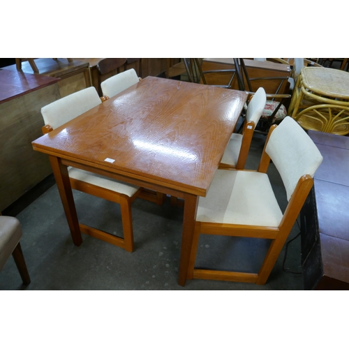 97 - A teak extending dining table and four chairs