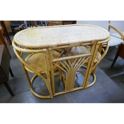 98 - A bamboo and rattan table and two chairs