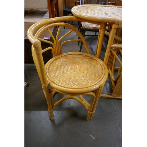 98 - A bamboo and rattan table and two chairs