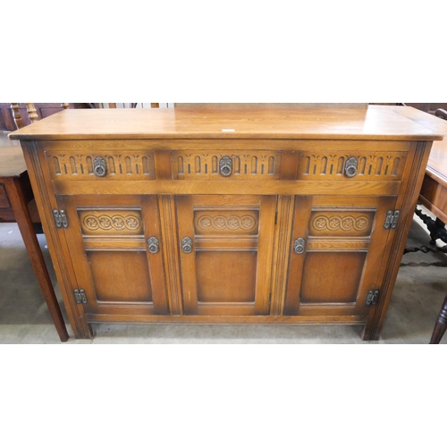 231 - A carved oak sideboard