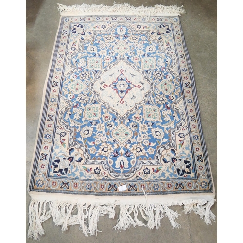 273 - A small eastern cream ground rug