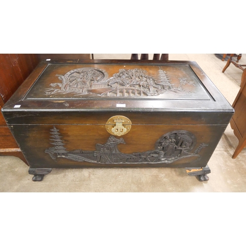 278 - An oriental carved camphorwood blanket box