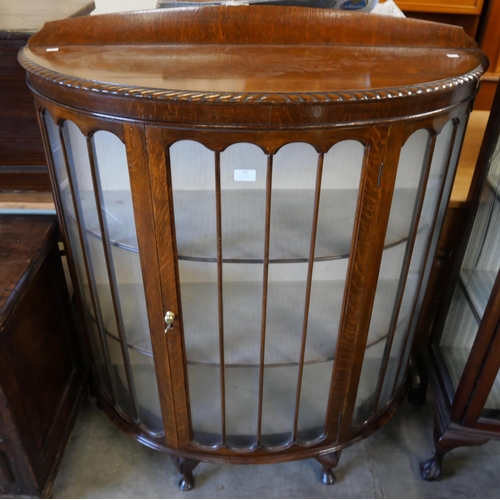 302 - An early 20th Century oak demi lune display cabinet