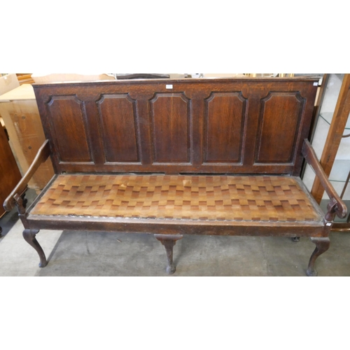 305 - A George III panelled oak settle