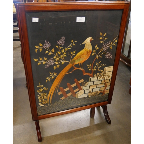 309 - A mahogany folding table/fire screen, with embroided pheasant panel