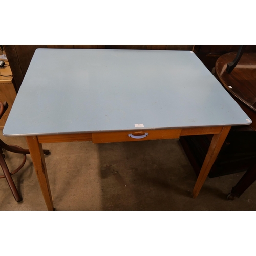 A teak and Formica topped kitchen table