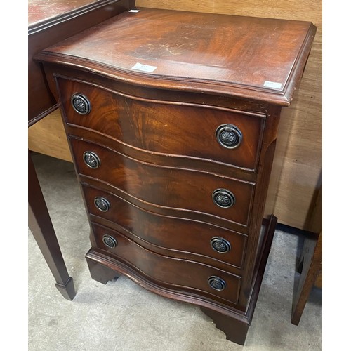 215 - A small George III style mahogany serpentine chest of drawers