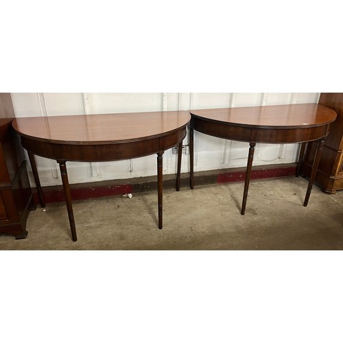 262 - A pair of George IV mahogany demi-lune console tables